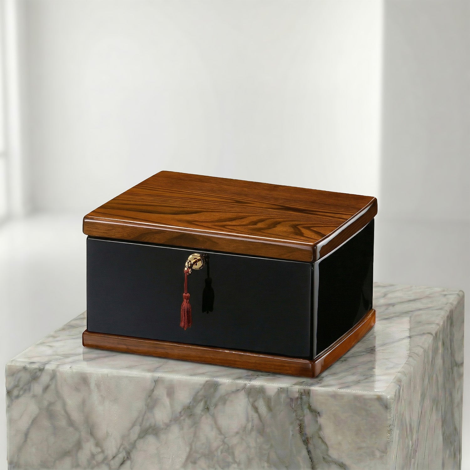 Wooden urn box with a black base on a marble surface