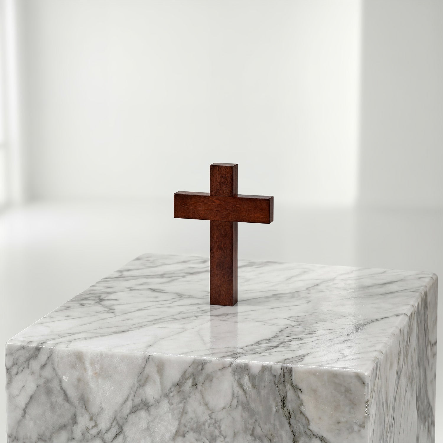 Wooden cross on a marble pedestal against a white background