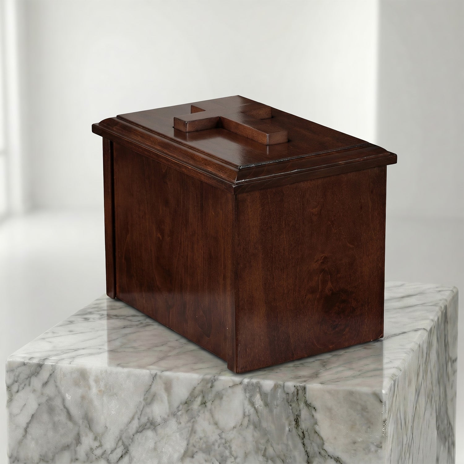 Wooden box on a marble pedestal against a white background