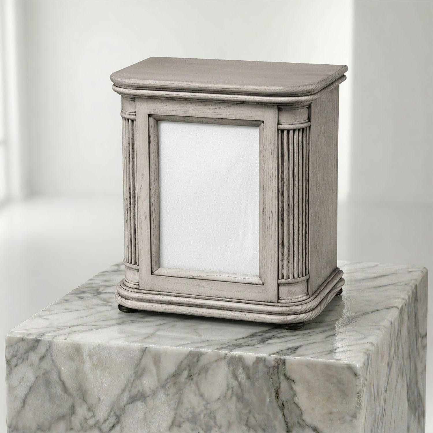 Decorative wooden portrait urn on a marble surface with a white background