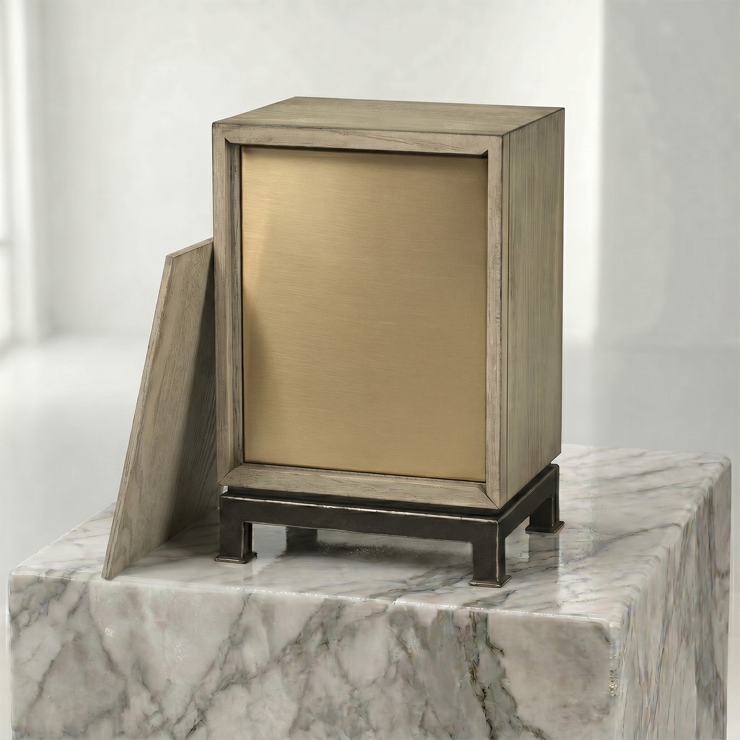 Back side of wooden urn with bronze insert on a marble surface