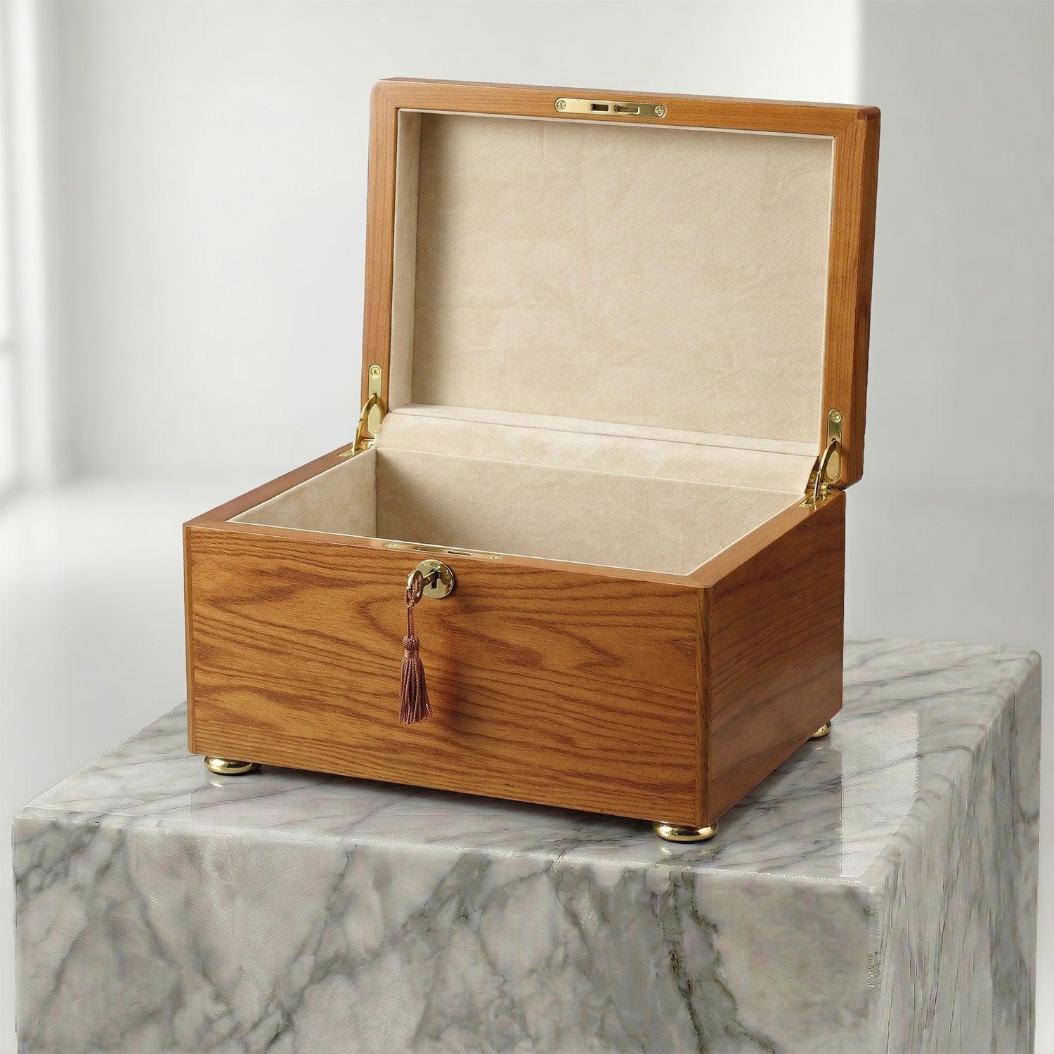 Golden Oak urn box with an open lid on a marble surface