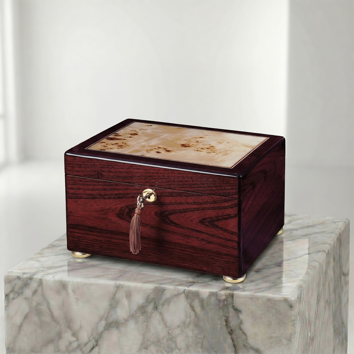 Wooden urn box with a decorative handle on a marble surface