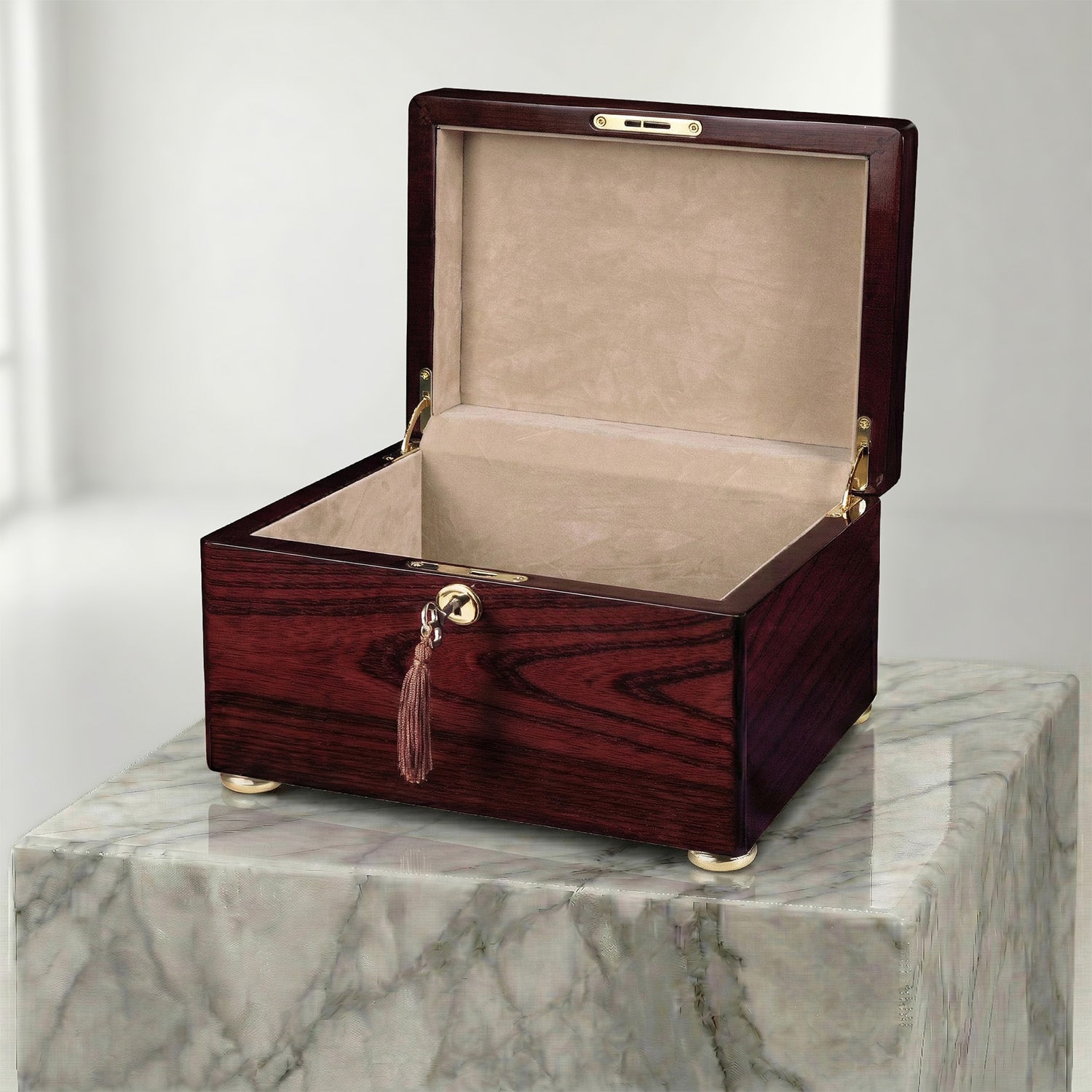 Wooden urn box with a tassel on a marble surface