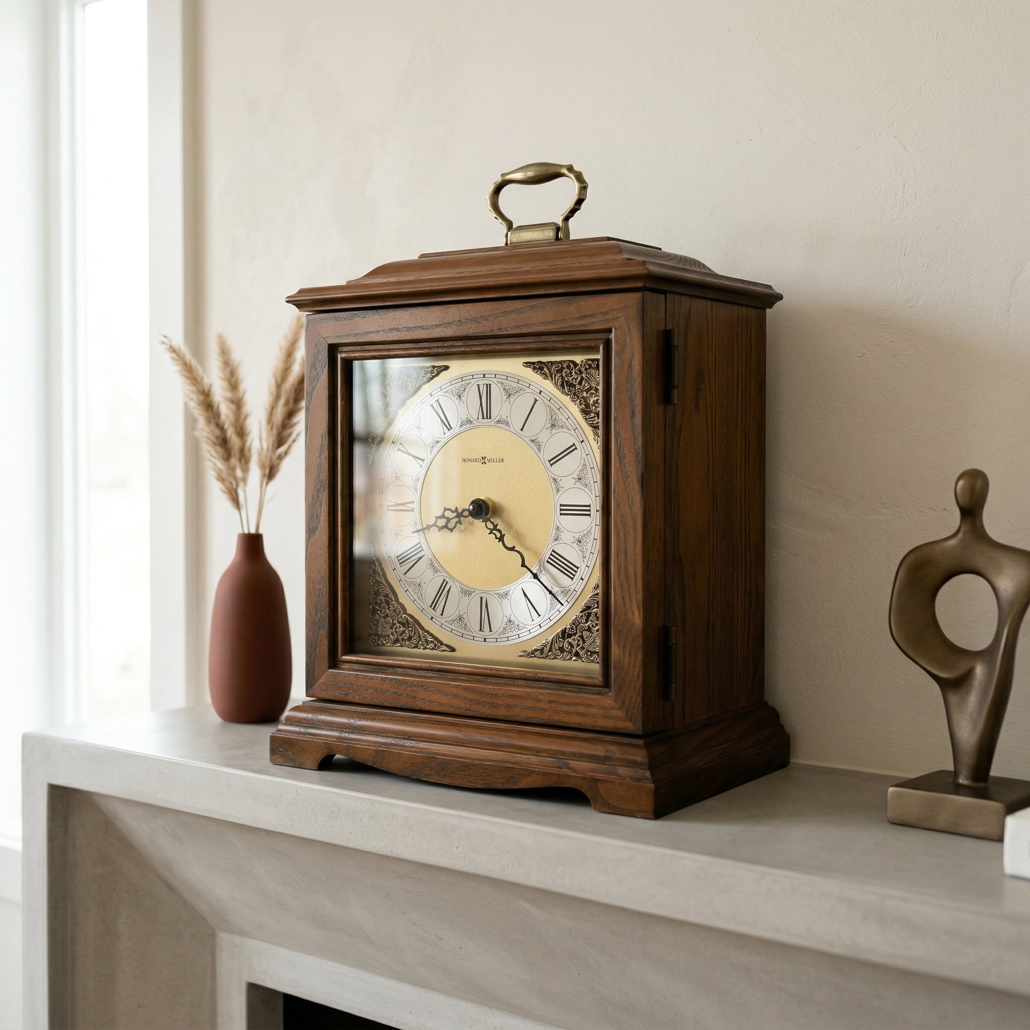 Wooden mantel clock urn on a shelf with decorative items
