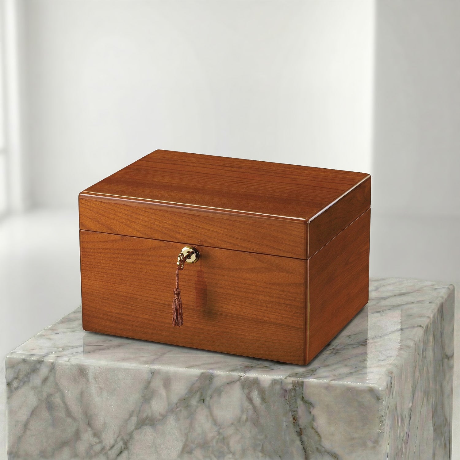 Wooden urn box with a gold clasp on a marble surface