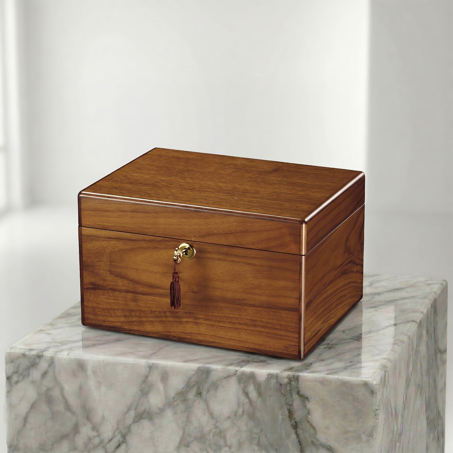 Wooden urn box with a gold clasp on a marble surface