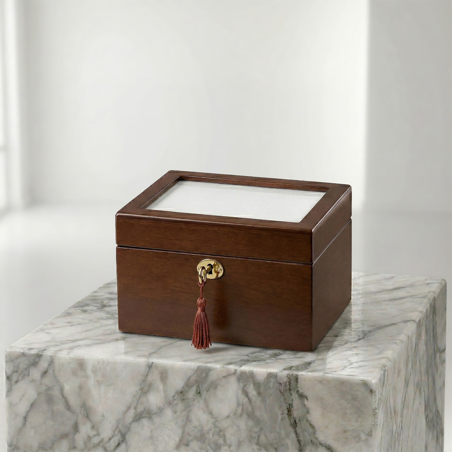 Brown urn box with a tassel on a marble surface