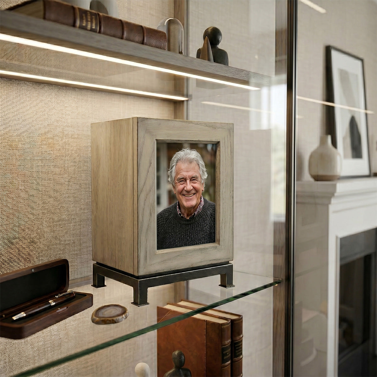 Framed photograph of a man in a photo urn on a shelf in a home setting