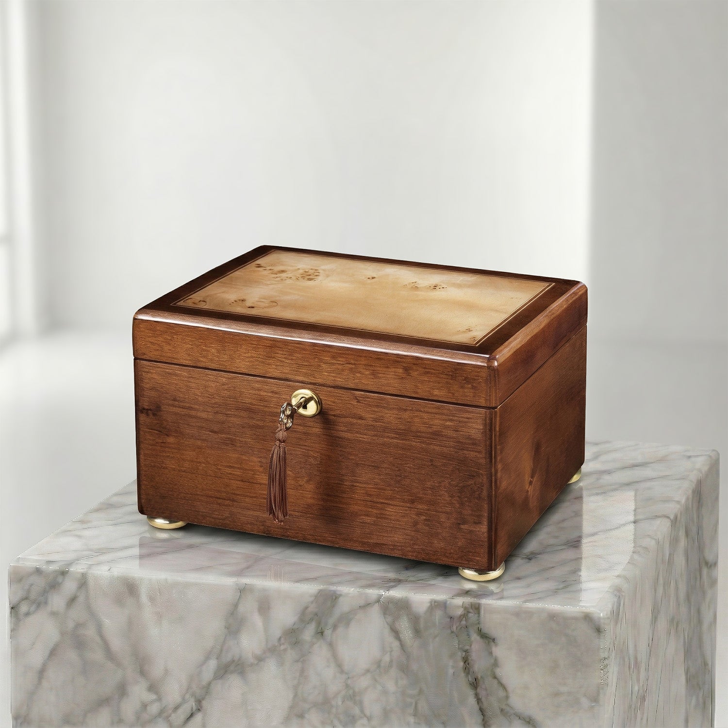 Wooden urn box with a tassel on a marble surface