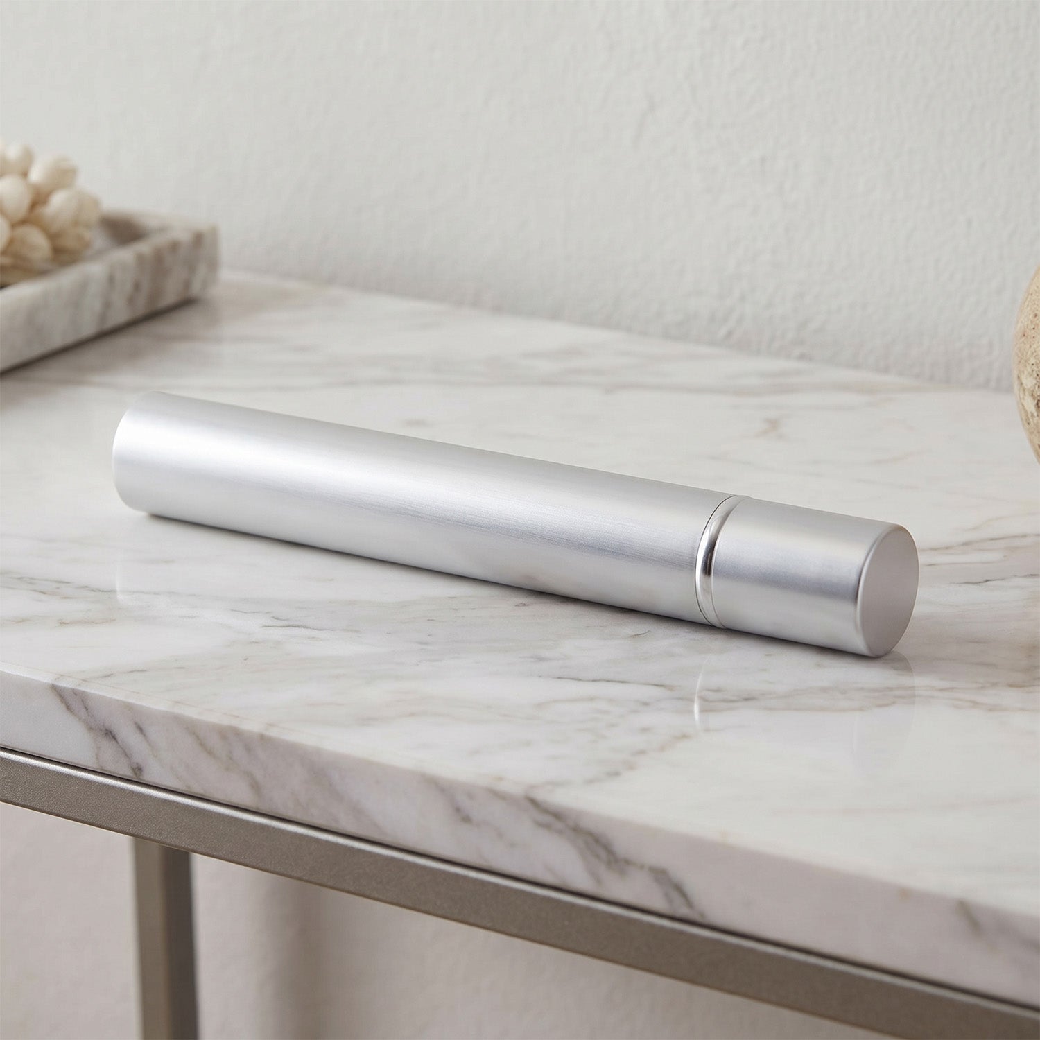 Silver scattering tube on a marble surface