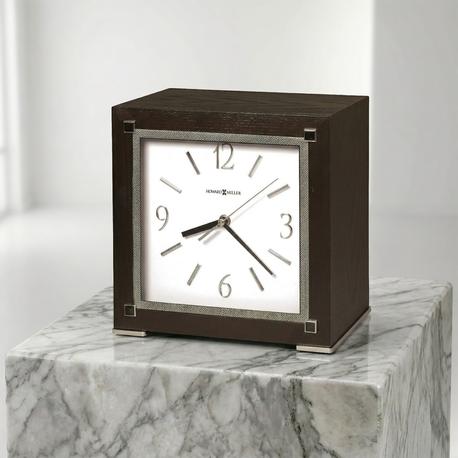 Square urn clock with brown wooden frame on a marble surface