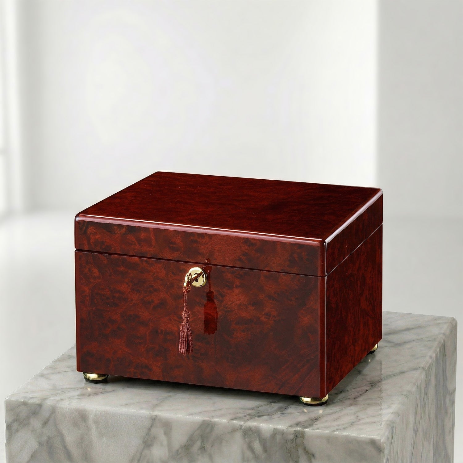 Wooden box urn with a gold clasp on a marble surface