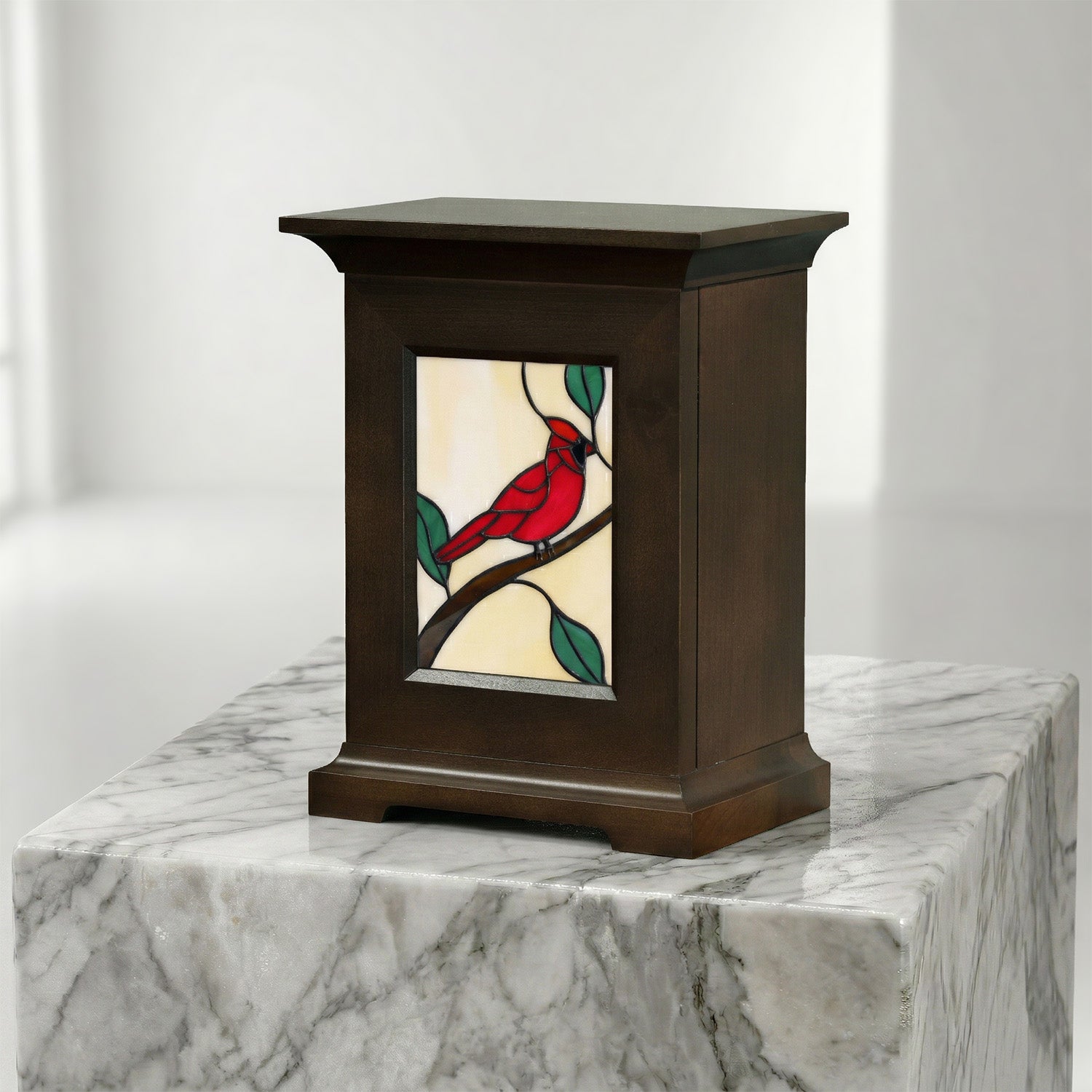 Decorative urn with stained glass panel of a red bird on a white background