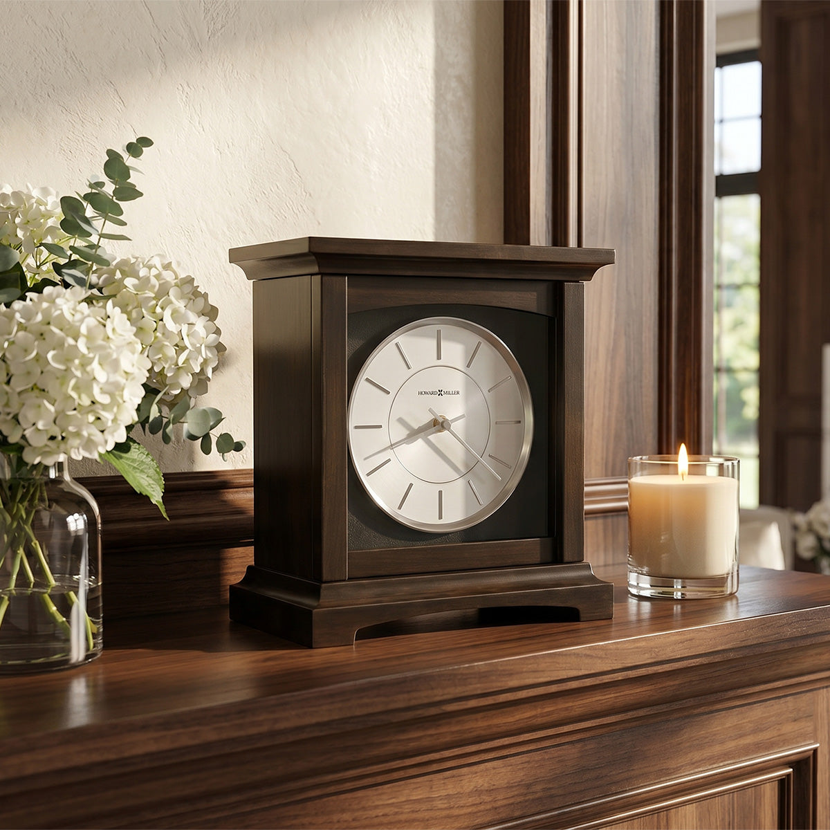 Wooden clock urn on a wooden surface with flowers and a candle in the background